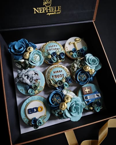 Nephele Cupcake Art rich chocolate cupcakes with elegant blue and gold decorations